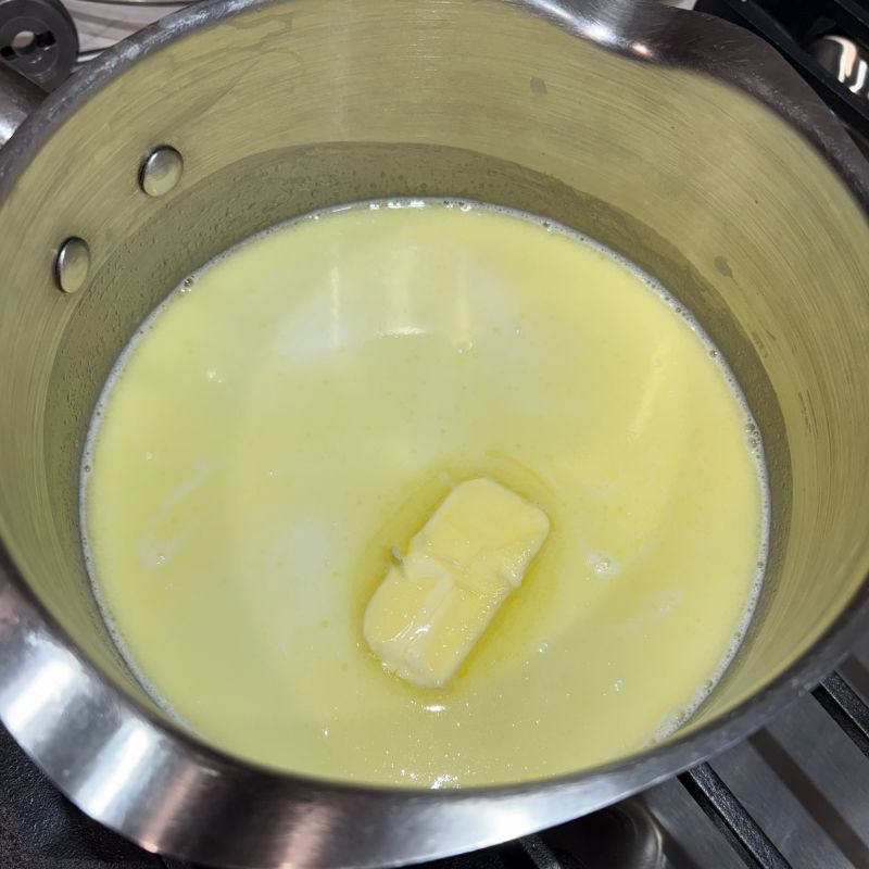 Melting the butter and sugar together for homemade cinnamon rolls.