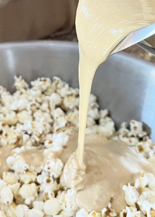 Pour marshmallow mixture over popcorn